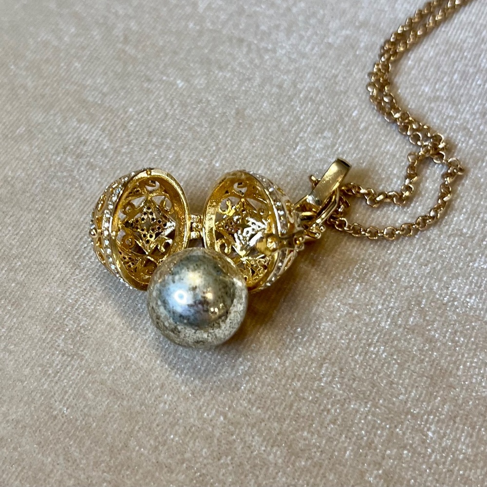 Whimsical necklace with chime bell inside, gold and crystal